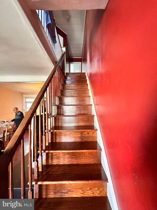 stairs with baseboards and wood finished floors