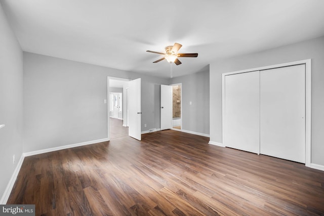 unfurnished bedroom featuring dark wood-style floors, a closet, ceiling fan, and baseboards