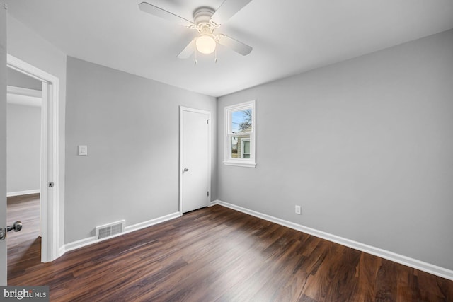 unfurnished bedroom featuring a ceiling fan, baseboards, visible vents, and dark wood-type flooring