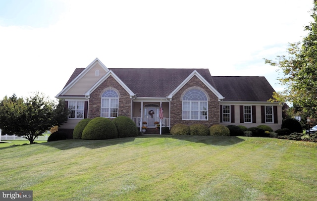 single story home with stone siding and a front yard