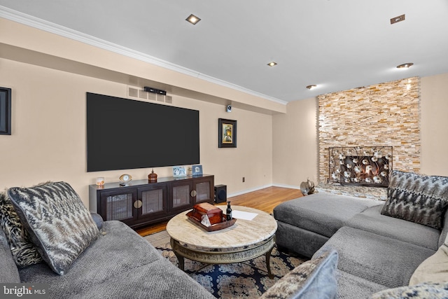 living area with ornamental molding, baseboards, and wood finished floors