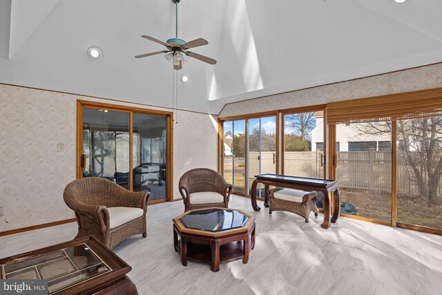 sitting room featuring high vaulted ceiling, ceiling fan, and wallpapered walls