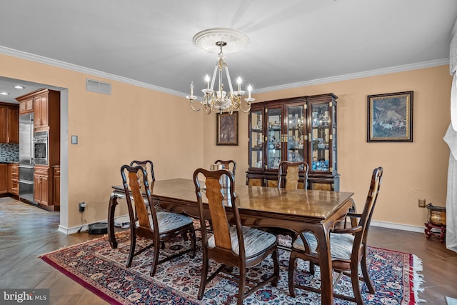 dining room featuring a chandelier, dark tile patterned flooring, visible vents, baseboards, and ornamental molding