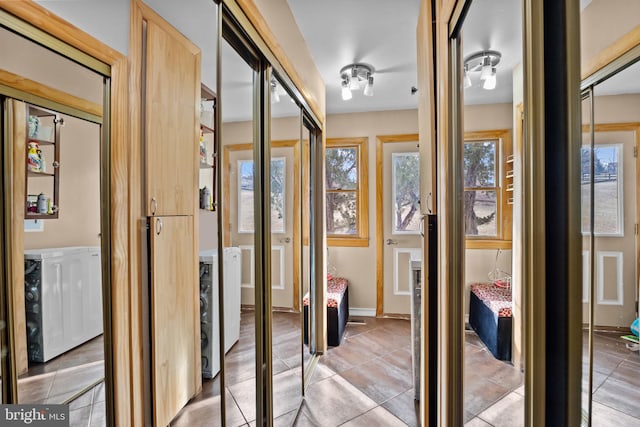 interior space with plenty of natural light, baseboards, and tile patterned flooring