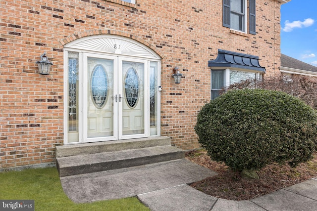 property entrance with brick siding