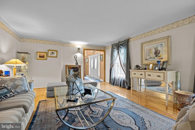 living room featuring ornamental molding and wood finished floors