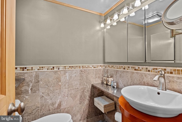 half bathroom featuring ornamental molding, tile walls, toilet, and vanity