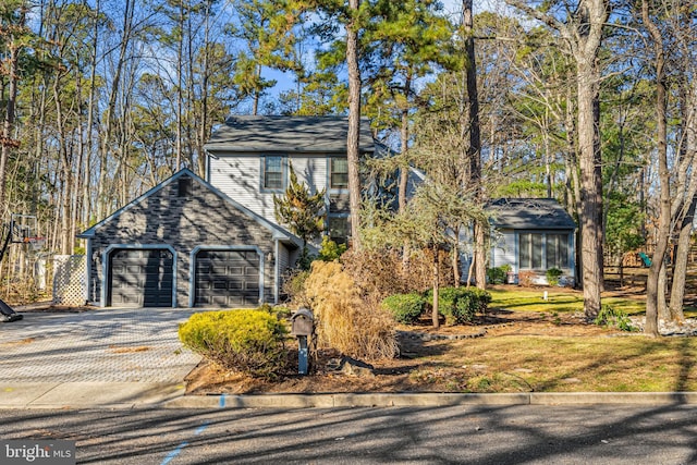 view of front of property with decorative driveway and an attached garage