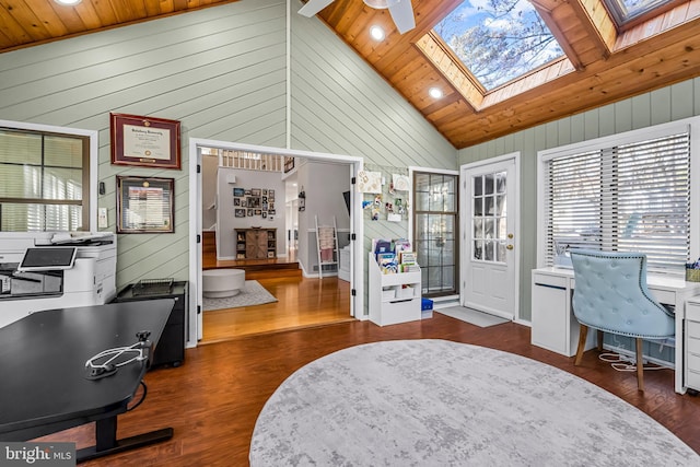 office space with high vaulted ceiling, a skylight, wooden ceiling, and wood finished floors