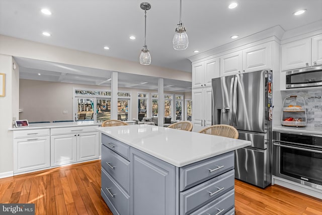 kitchen featuring appliances with stainless steel finishes, white cabinets, and gray cabinetry