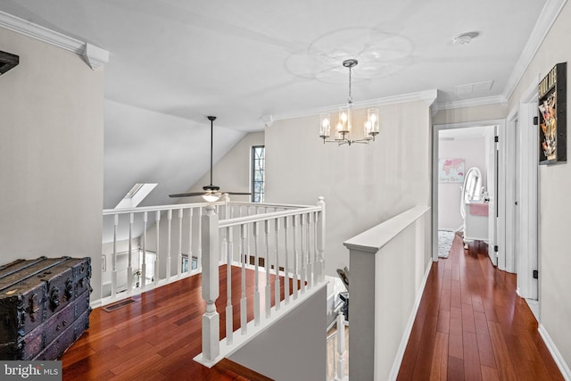 corridor featuring lofted ceiling, visible vents, an upstairs landing, ornamental molding, and wood-type flooring