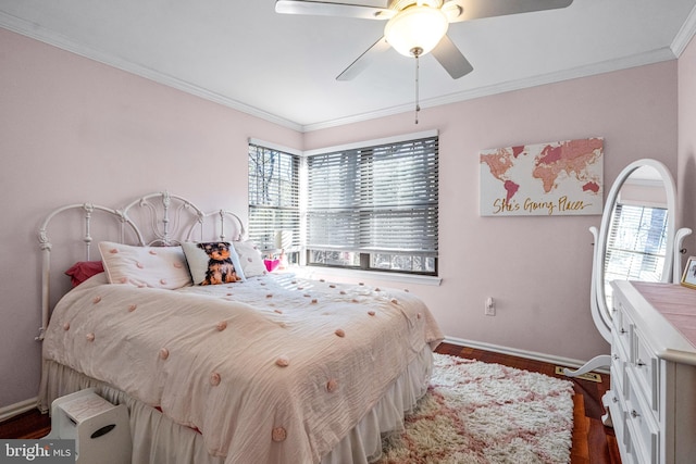 bedroom featuring dark wood-style floors, multiple windows, baseboards, and crown molding