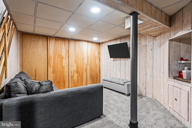 interior space featuring carpet floors, wood walls, a drop ceiling, and recessed lighting