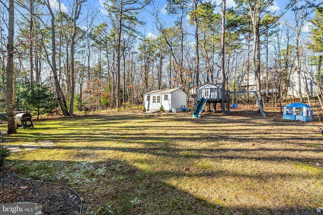 view of yard with a playground and an outbuilding