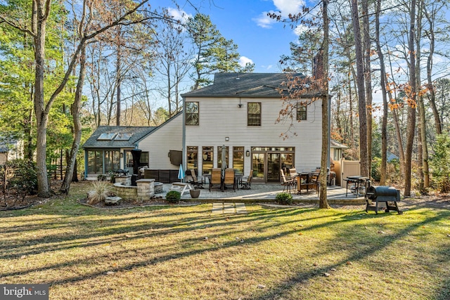 back of house with a yard, a chimney, and a patio