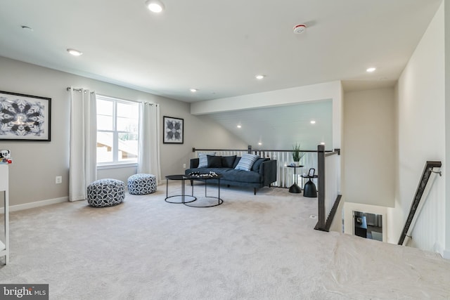 sitting room featuring recessed lighting, light carpet, and an upstairs landing