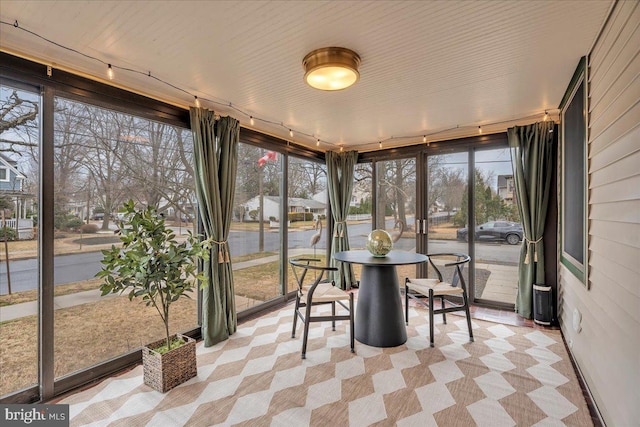 unfurnished sunroom with track lighting