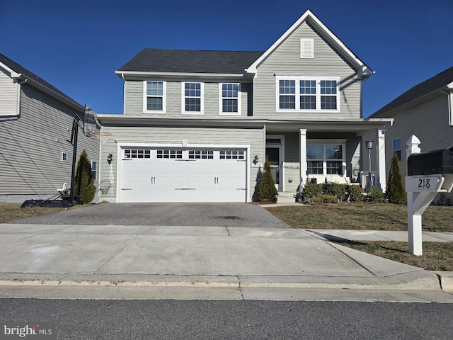 traditional-style home featuring driveway, a garage, and a porch