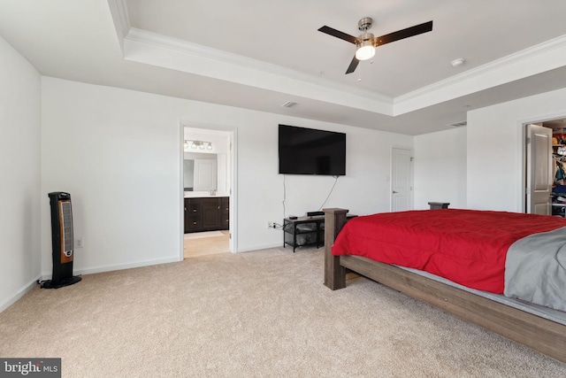 bedroom with light colored carpet, baseboards, ornamental molding, and a raised ceiling