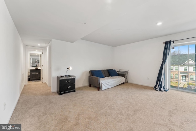 sitting room featuring baseboards, recessed lighting, and light colored carpet