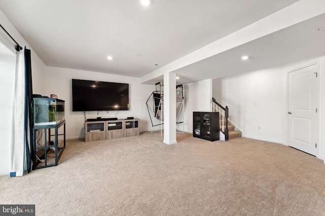 finished below grade area with baseboards, carpet floors, stairs, and recessed lighting