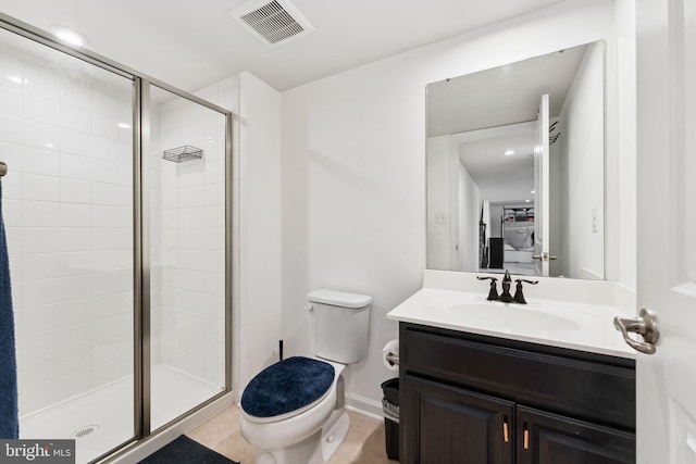 bathroom featuring toilet, vanity, a stall shower, and visible vents
