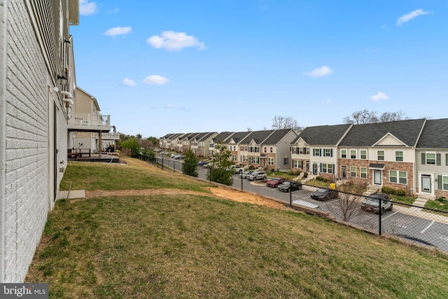 view of yard featuring fence and a residential view