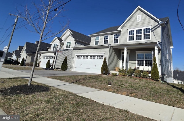 traditional-style home with a garage, a front lawn, and driveway