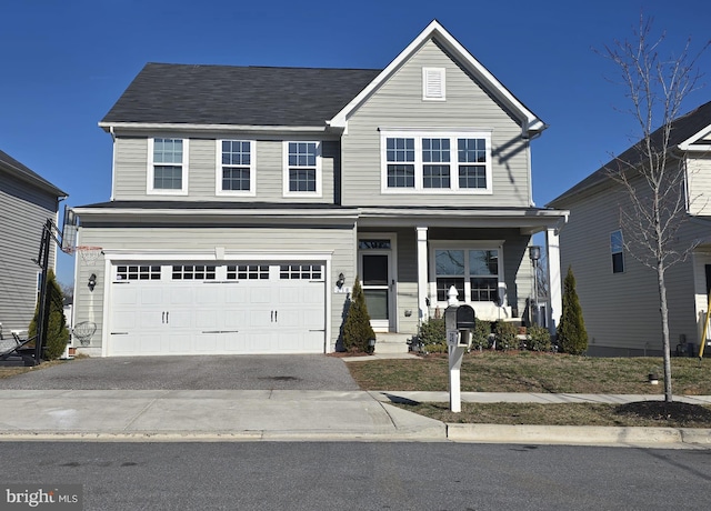 traditional-style home featuring aphalt driveway, covered porch, and an attached garage