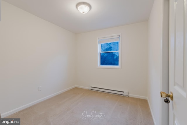 carpeted spare room featuring a baseboard radiator and baseboards