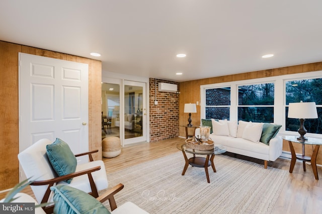 living area featuring a wall mounted AC, wood finished floors, and recessed lighting