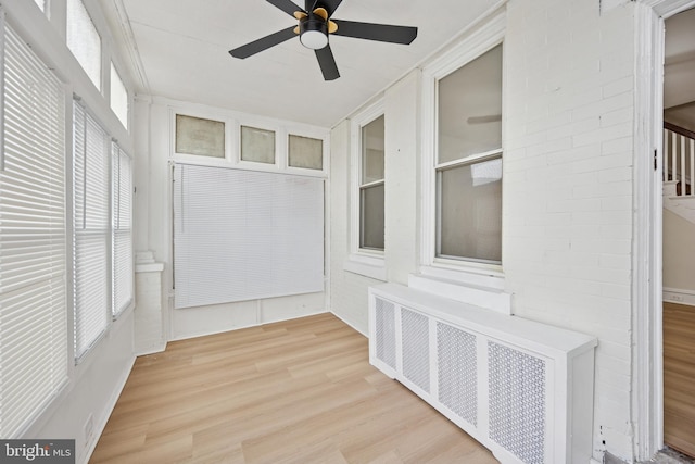 interior space featuring a ceiling fan and radiator