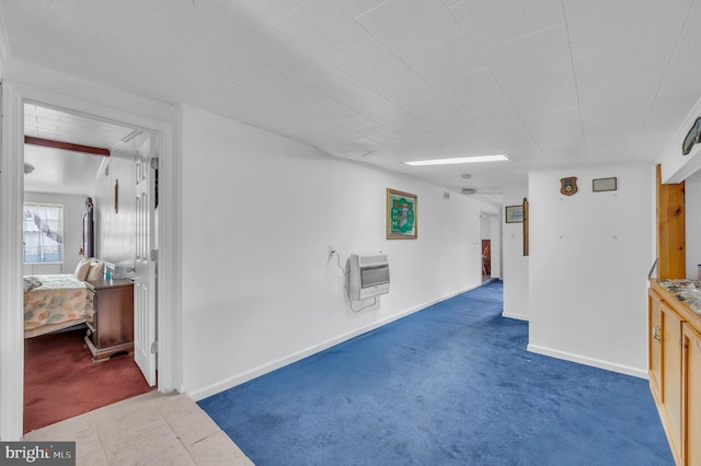 interior space featuring baseboards and heating unit