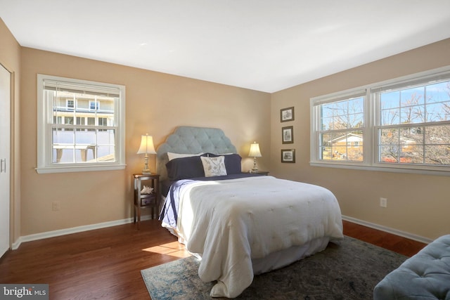 bedroom with baseboards and wood finished floors