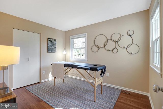 home office with visible vents, baseboards, and wood finished floors