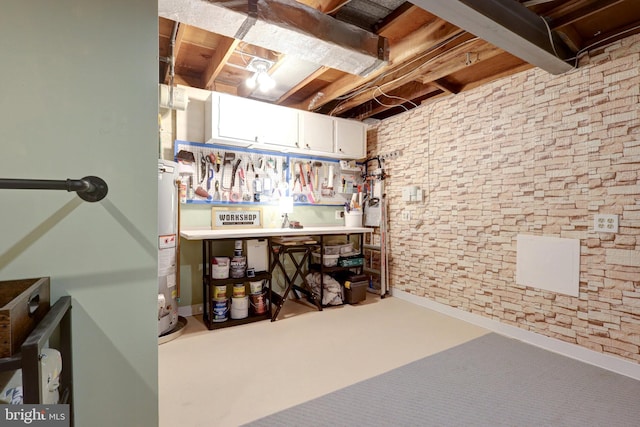 unfinished basement with gas water heater and a workshop area