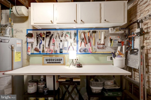 interior space featuring open shelves, gas water heater, light countertops, and white cabinetry