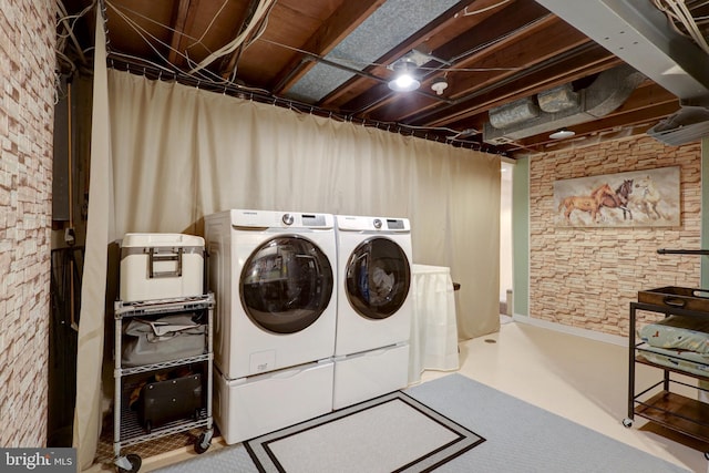 clothes washing area featuring laundry area and washing machine and clothes dryer