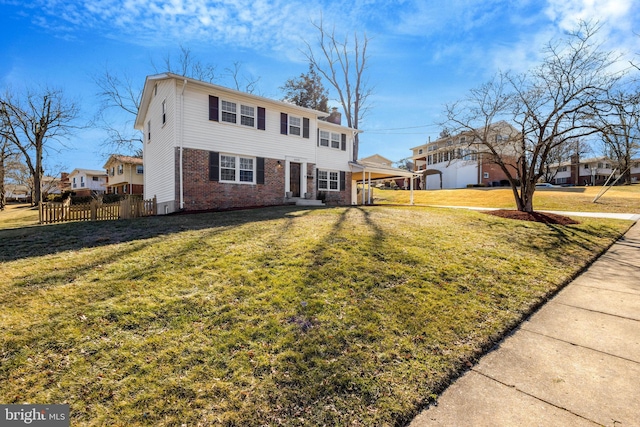 view of front of house featuring a chimney, a front yard, fence, and brick siding