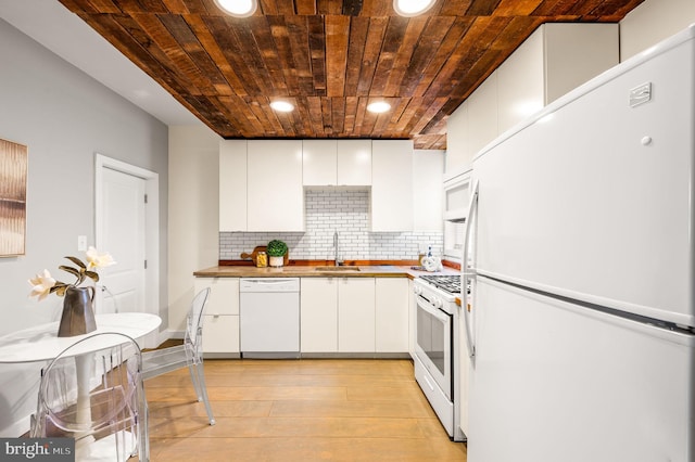 kitchen with butcher block counters, wooden ceiling, white cabinets, a sink, and white appliances