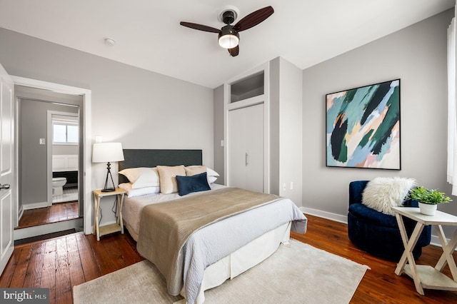 bedroom featuring dark wood-style floors, baseboards, and a ceiling fan