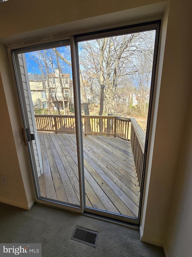 entryway with carpet and visible vents