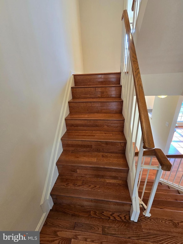 stairs with wood finished floors