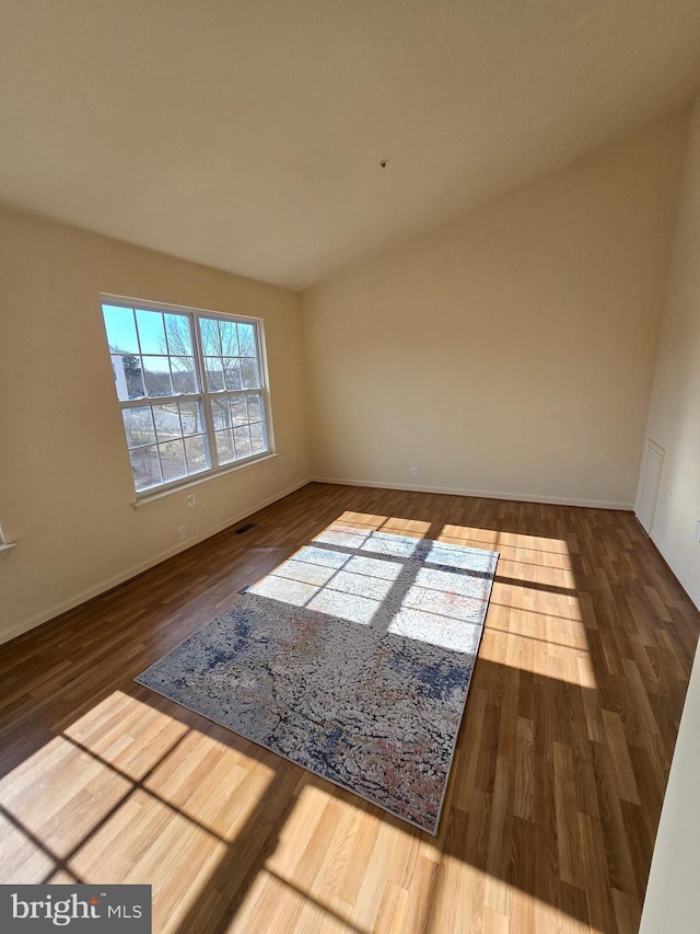 spare room with visible vents and wood finished floors