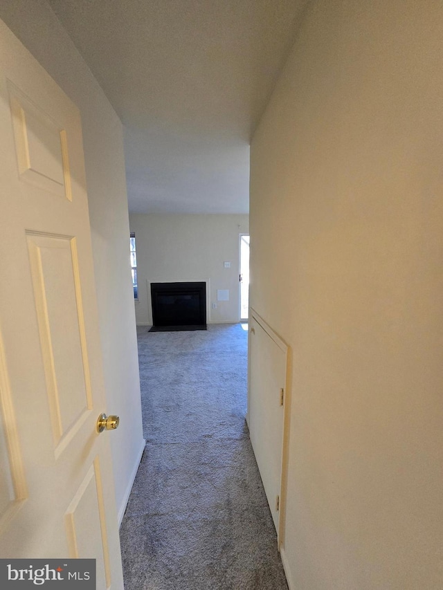 hall with carpet floors and baseboards