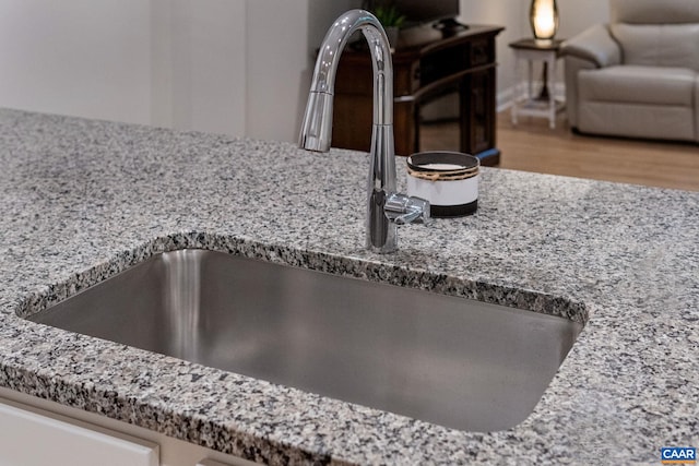 interior details featuring stone counters, a sink, and a fire pit