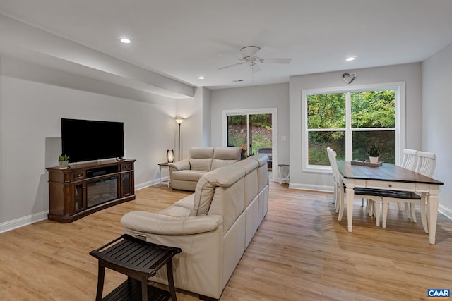 living area with recessed lighting, baseboards, and light wood finished floors