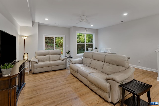 living room featuring a ceiling fan, light wood-type flooring, baseboards, and recessed lighting