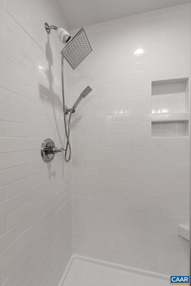 bathroom with a tile shower