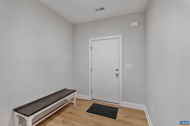 foyer featuring baseboards, visible vents, and light wood-style floors